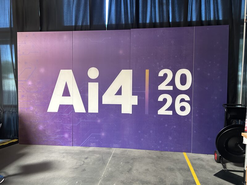 Purple AI4 2026 media wall with large white lettering
