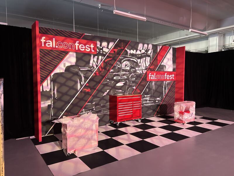 Full-bleed event backdrop wall staged for a Las Vegas show — printed by Red Bliss