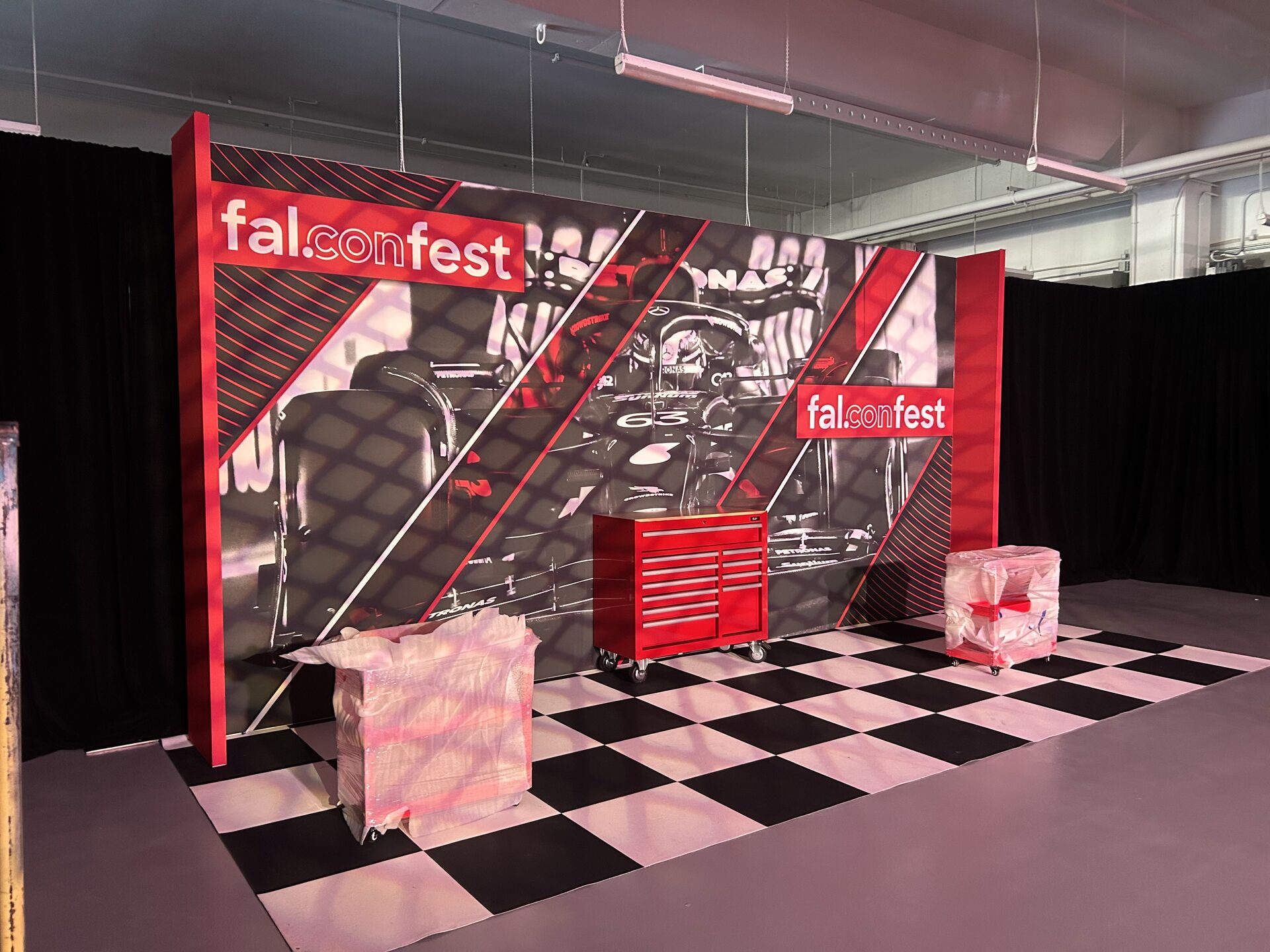 Full-bleed event backdrop wall staged for a Las Vegas show — printed by Red Bliss