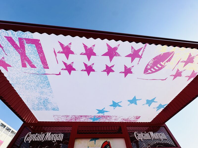Underside of a Captain Morgan event canopy printed with pink and blue stars