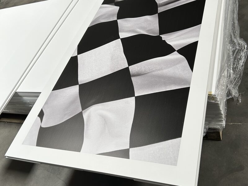 Black and white checkerboard graphic laid flat on a worktable before installation