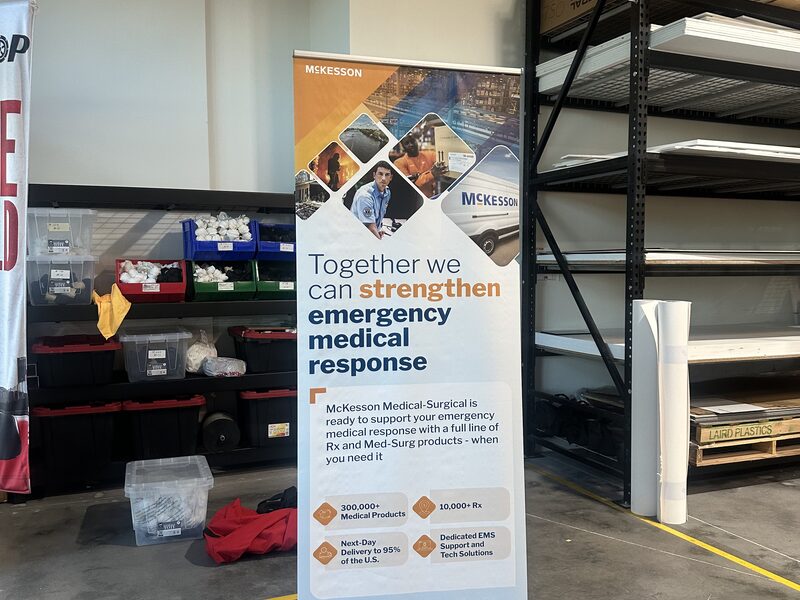 Retractable printed banner about emergency medical response standing in a workspace