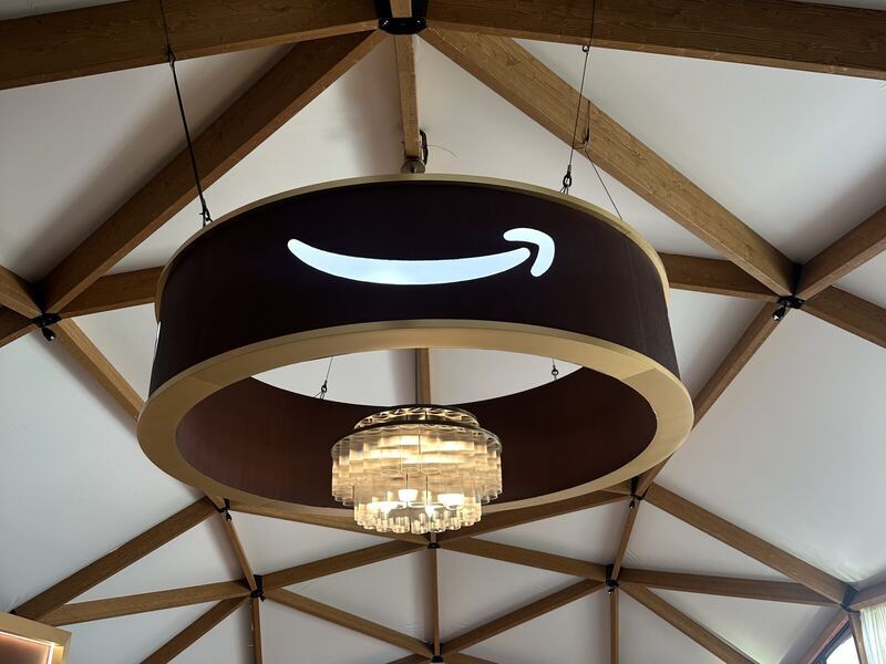 Hanging sign rigged above a trade show booth — printed by Red Bliss, Las Vegas