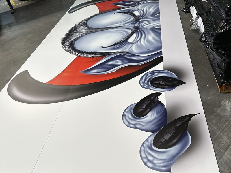Illustrated large-format printed panels laid out for production inspection