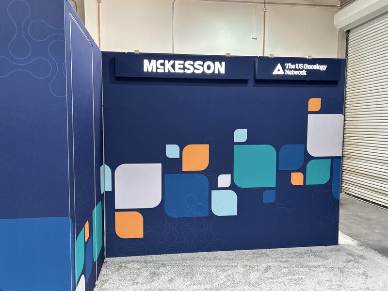 McKesson exhibition wall with deep blue background and colorful square graphics