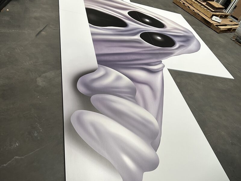 Oversized printed character graphic being checked on the production floor