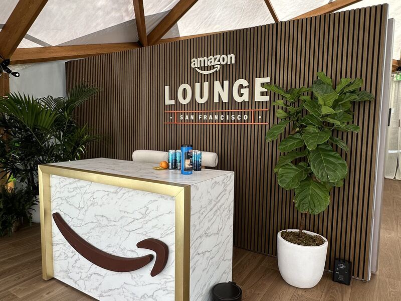Branded event registration counter and backdrop in a lounge setting