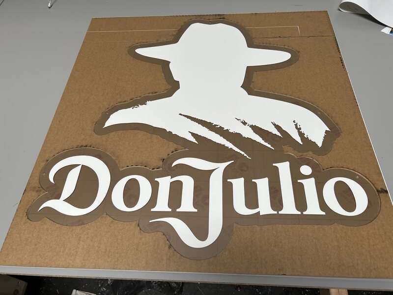 White Cowboy Limo dimensional logo mounted on a wood panel