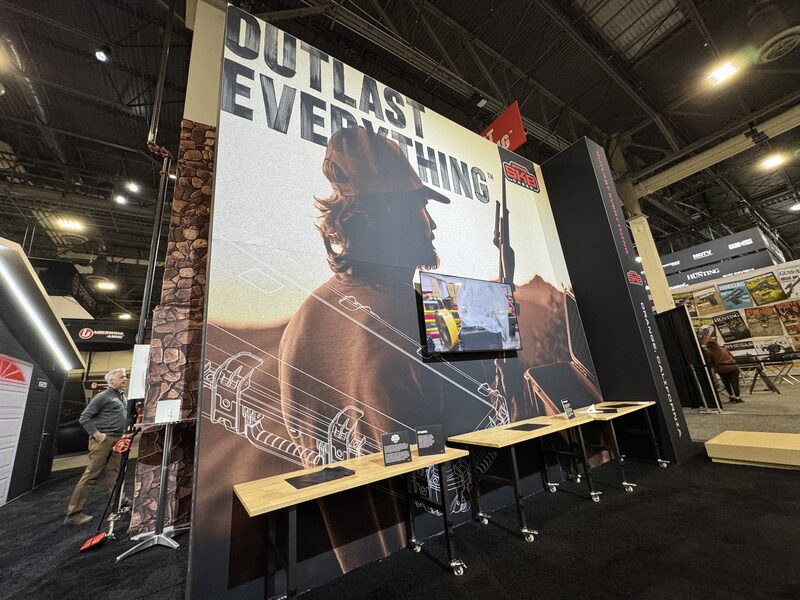 SKB Cases exhibit with a tall Outlast Everything printed graphic and mounted screen
