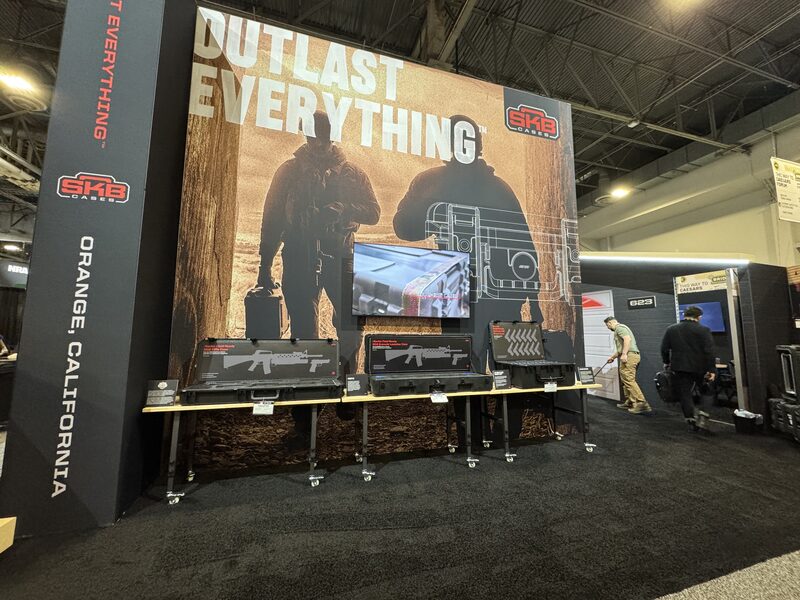 SKB Cases trade show booth with an oversized printed wall and product shelves
