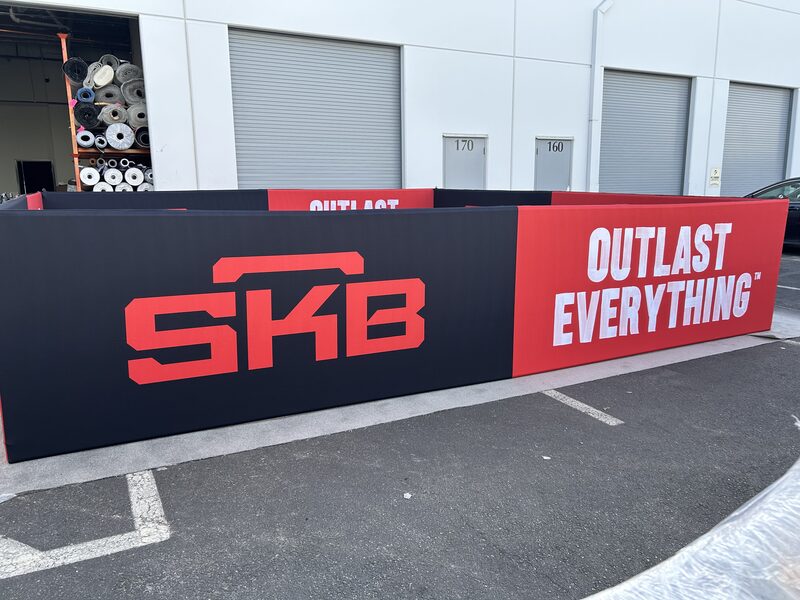 Outdoor SKB Cases branded barrier with large red lettering and white tagline