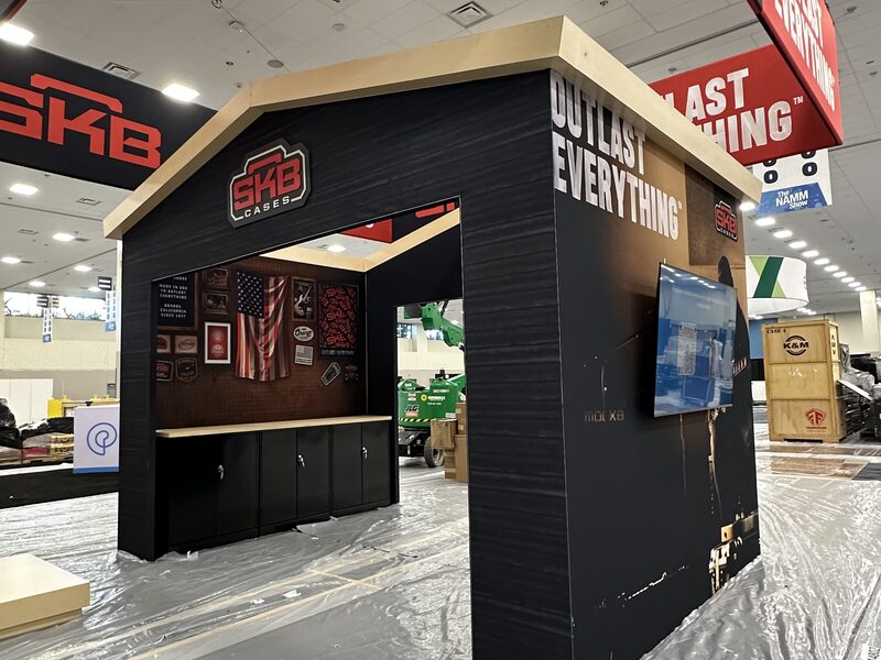 Black SKB Cases booth structure on an exhibit floor during setup