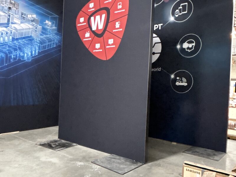 Black SKB Cases exhibit panels with red and white graphics during assembly