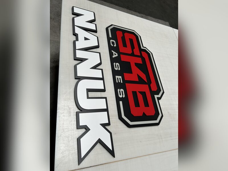 Raised SKB Cases logo lettering viewed at an angle in a production space
