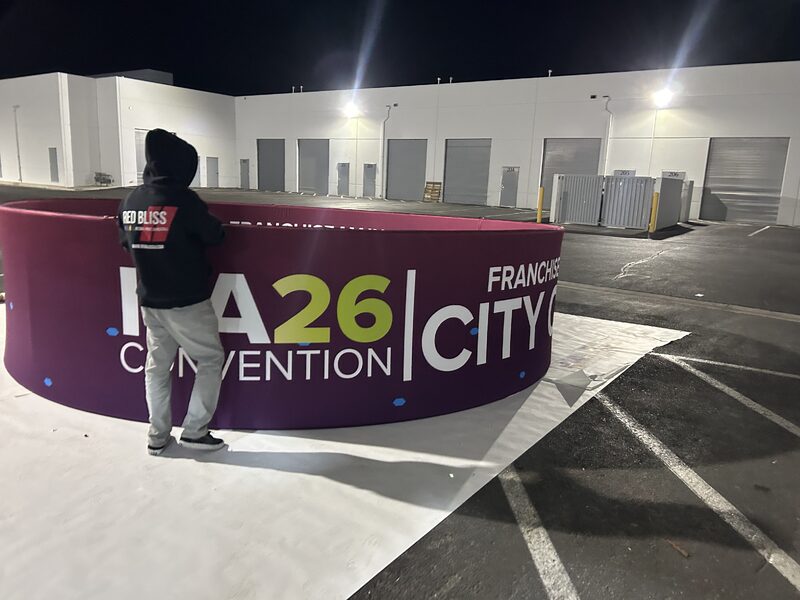 Printed Convention City graphic on a curved trade show counter