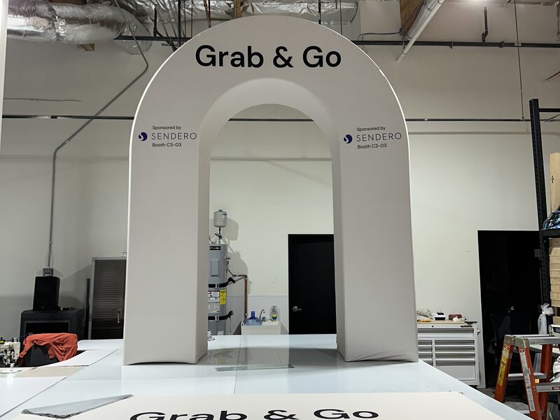 White Grab and Go exhibit structure with an arched service opening