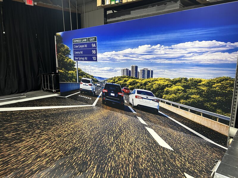 Immersive roadway display with printed landscape walls and flooring