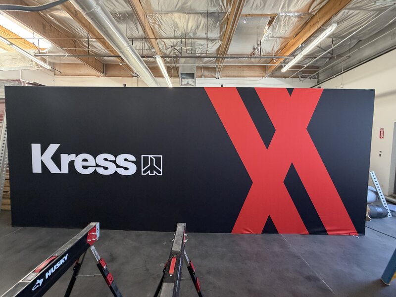 Black Kress exhibit wall with a large red geometric graphic