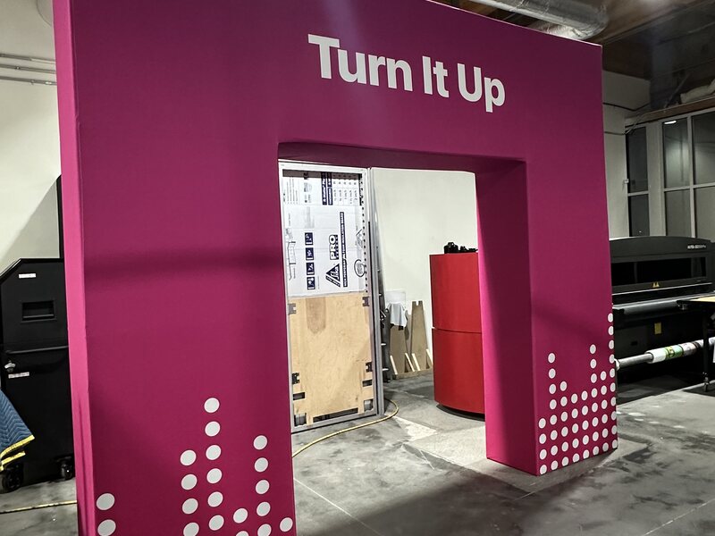 Magenta Turn It Up archway with white lettering and dot graphics